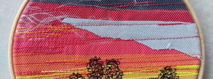 Auringonlasku tilkkumaalaten kehystettynä